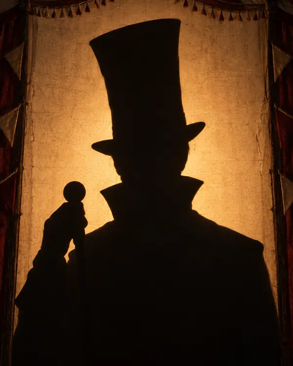 A player not revealed yet: a shadow behind a lit screen